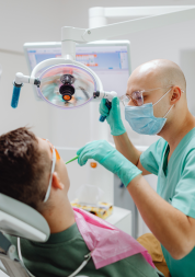 A dentist performing dental surgery on a patient.
