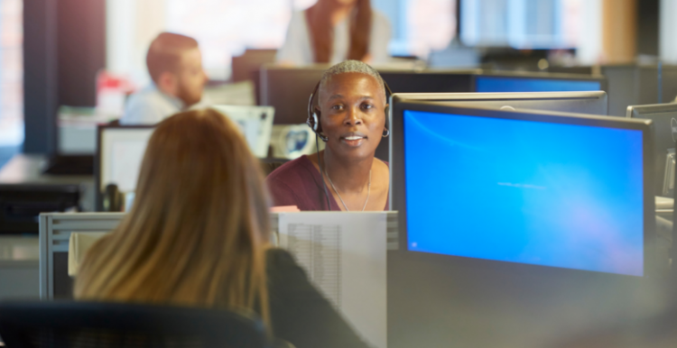 People using headsets and looking at computer screens in a call centre