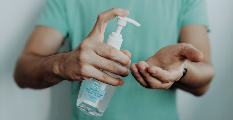 A person using hand sanitiser