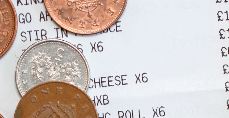 Coins on top of a shopping receipt