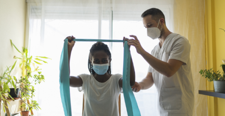 A woman receiving physical therapy after a stroke